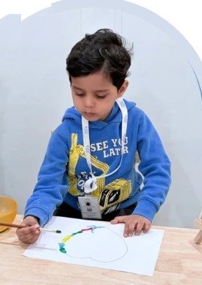A Della Junior student painting in class